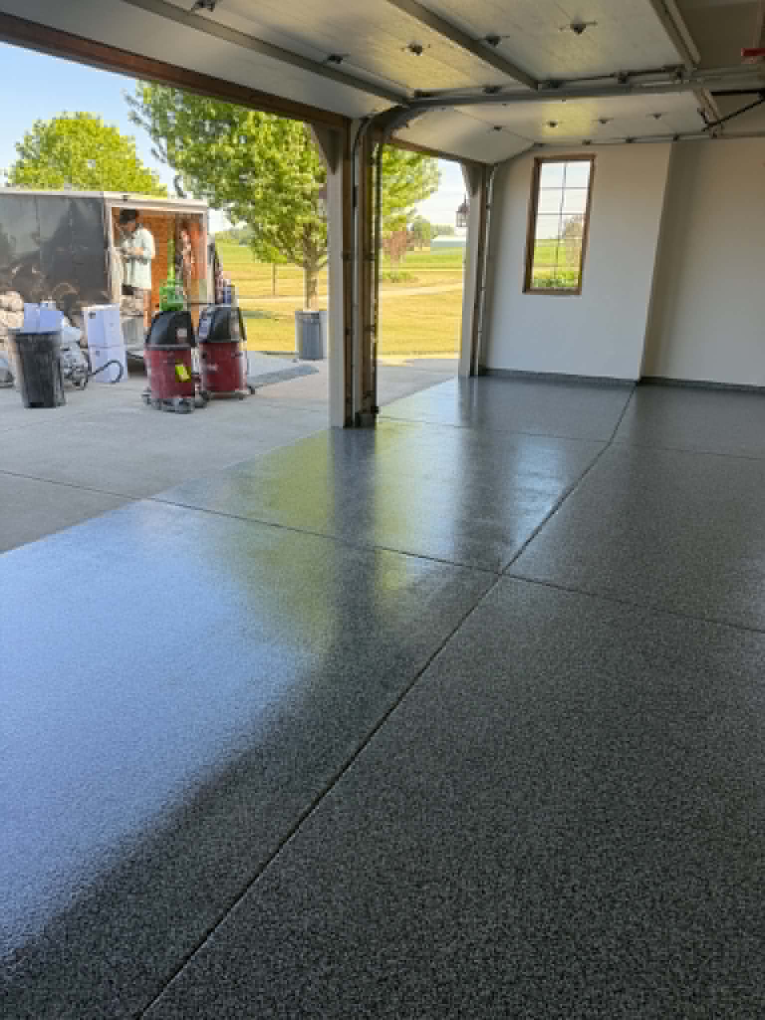 750 sq ft Garage Epoxy coated garage floor with a reflective silver and charcoal flake finish installed by Northwoods Coatings