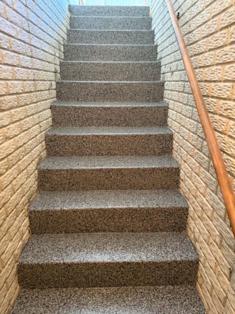 Front porch and entryway concrete steps sealed with granite gray polyaspartic coating and color chips