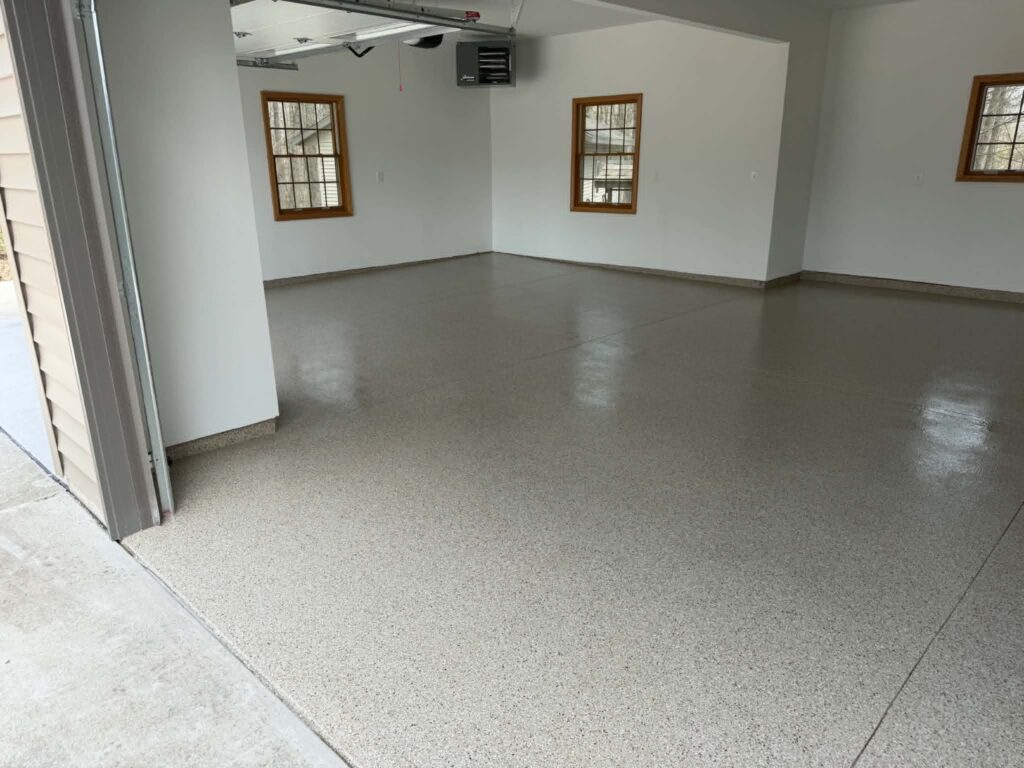 Three car residential garage floor coated with coffee brown and tan decorative flake polyaspartic finish