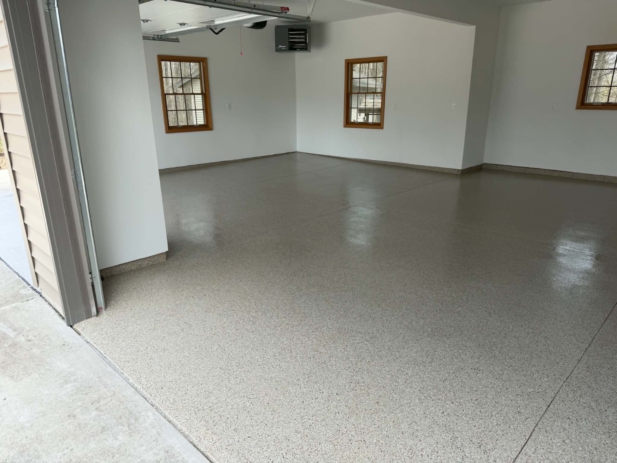 Three car residential garage floor coated with coffee brown and tan decorative flake polyaspartic finish